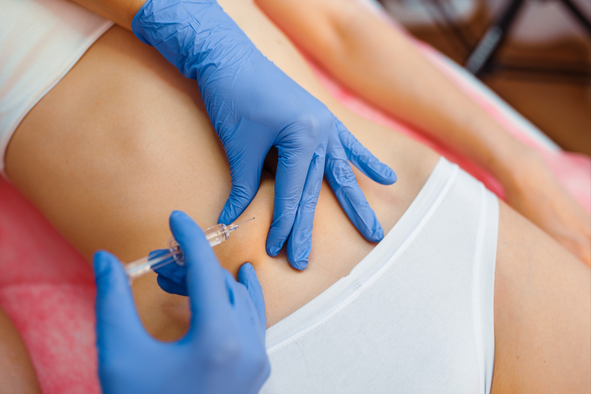 cosmetician-gives-botox-injection-in-the-stomach