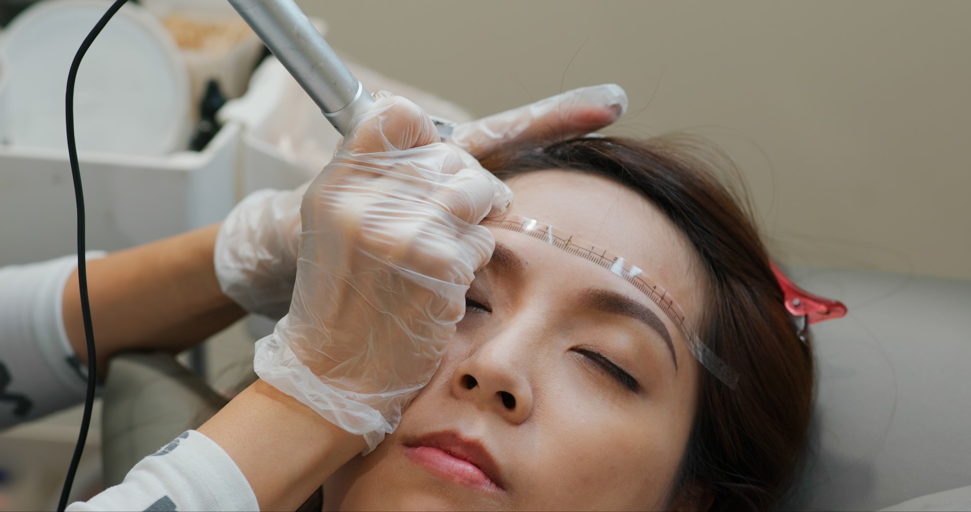 woman-undergo-eyebrow-microblading-permanent-makeu